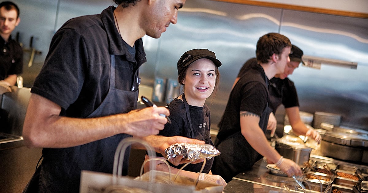 Chipotle team members working the make line. 