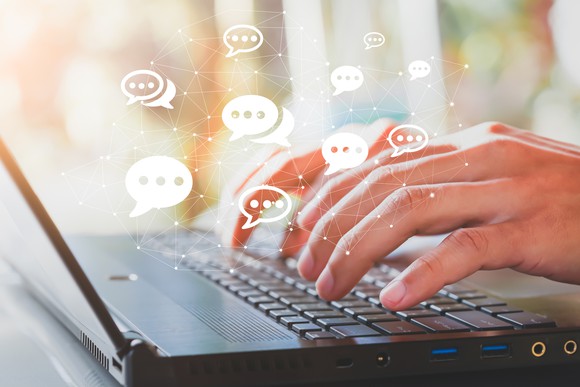 A man types messages in an online forum.