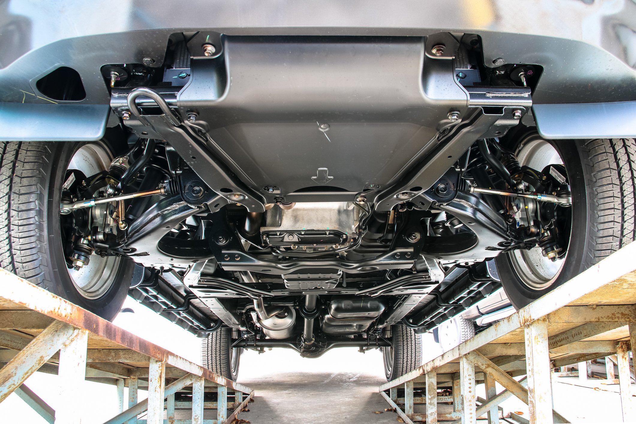 The underside of a car revealing the transmission and engine.