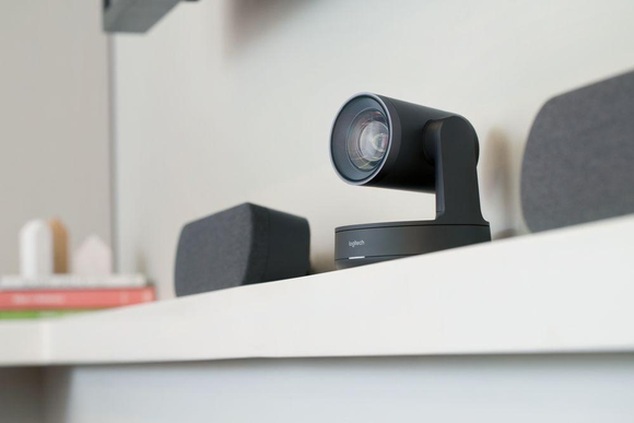 A video camera sitting on a shelf in an office.