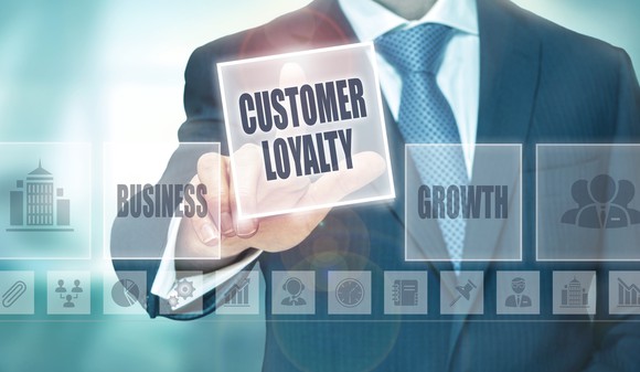 Businessman pointing to "Customer Loyalty"