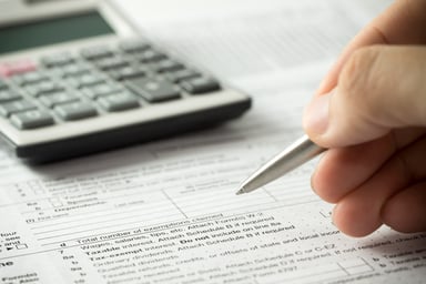 tax form with calculator_GettyImages-520834230