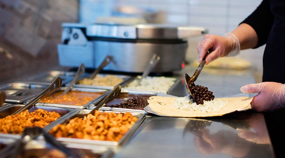 Chipotle employee preparing food.