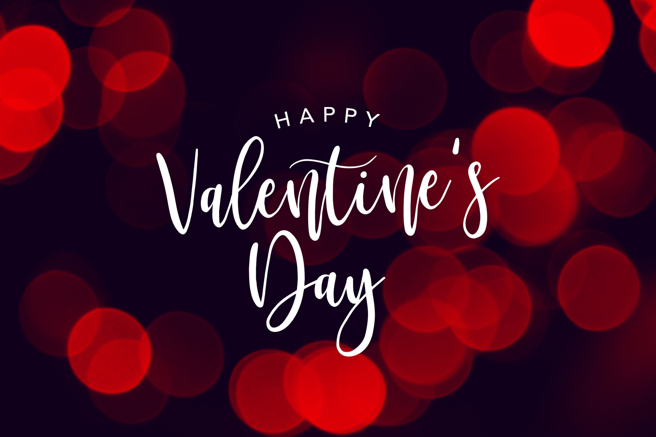 The words happy Valentine's Day in white against black background with red circles