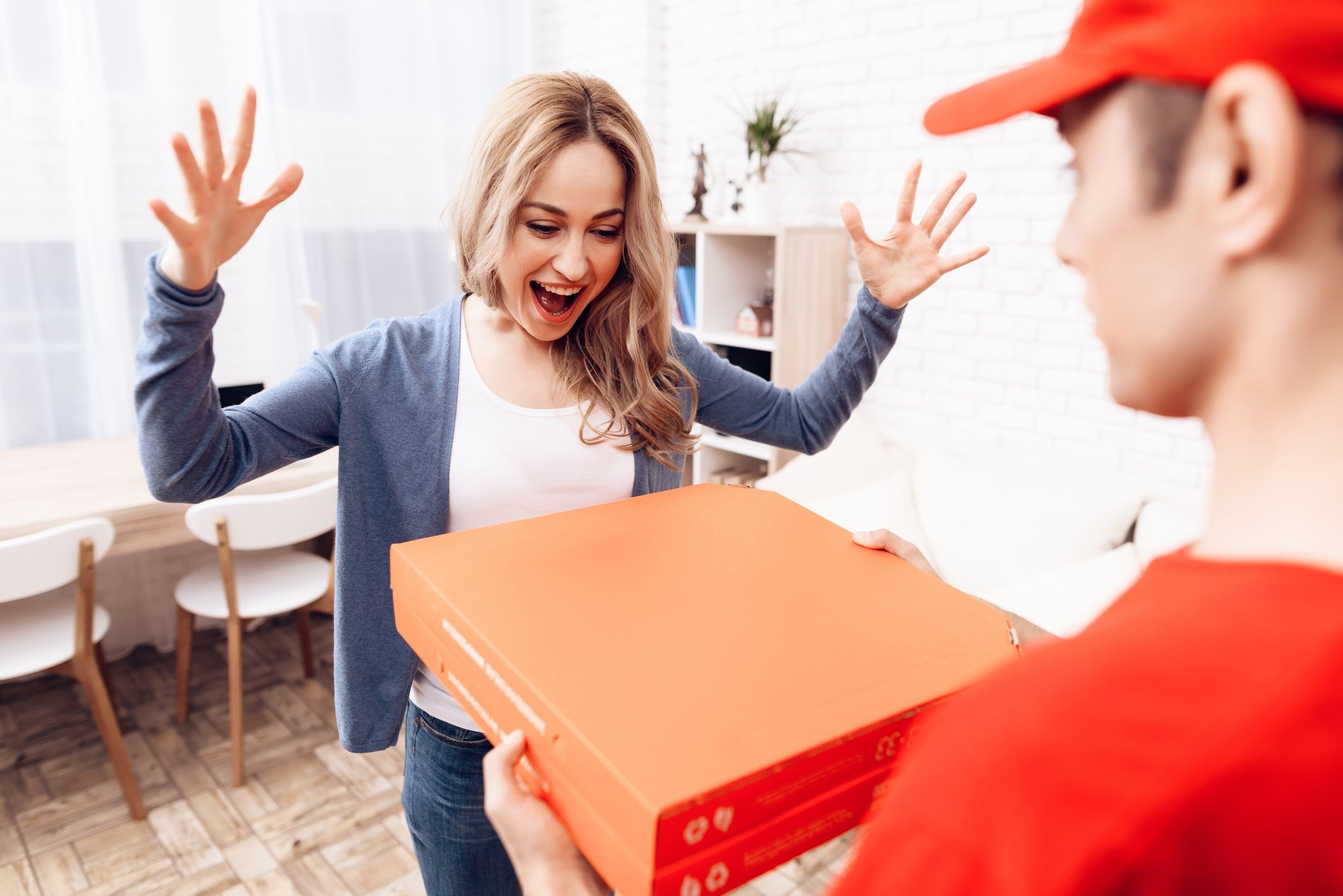 Woman excited over receiving pizza delivery