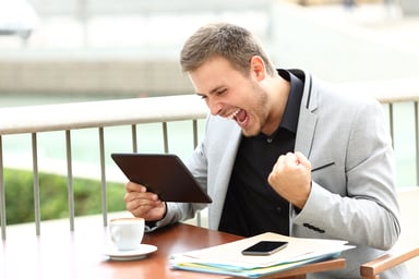 AG excited businessman with tablet and phone