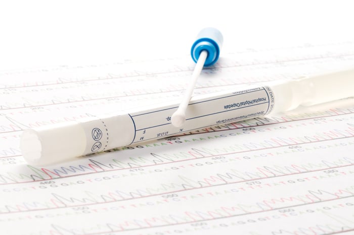 A buccal swab on a print out of a genetic test.