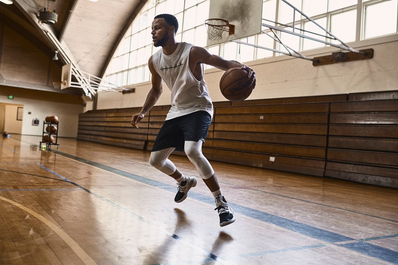 NBA basketball player and Under Armour athlete Stephen Curry dribbling a basketball.