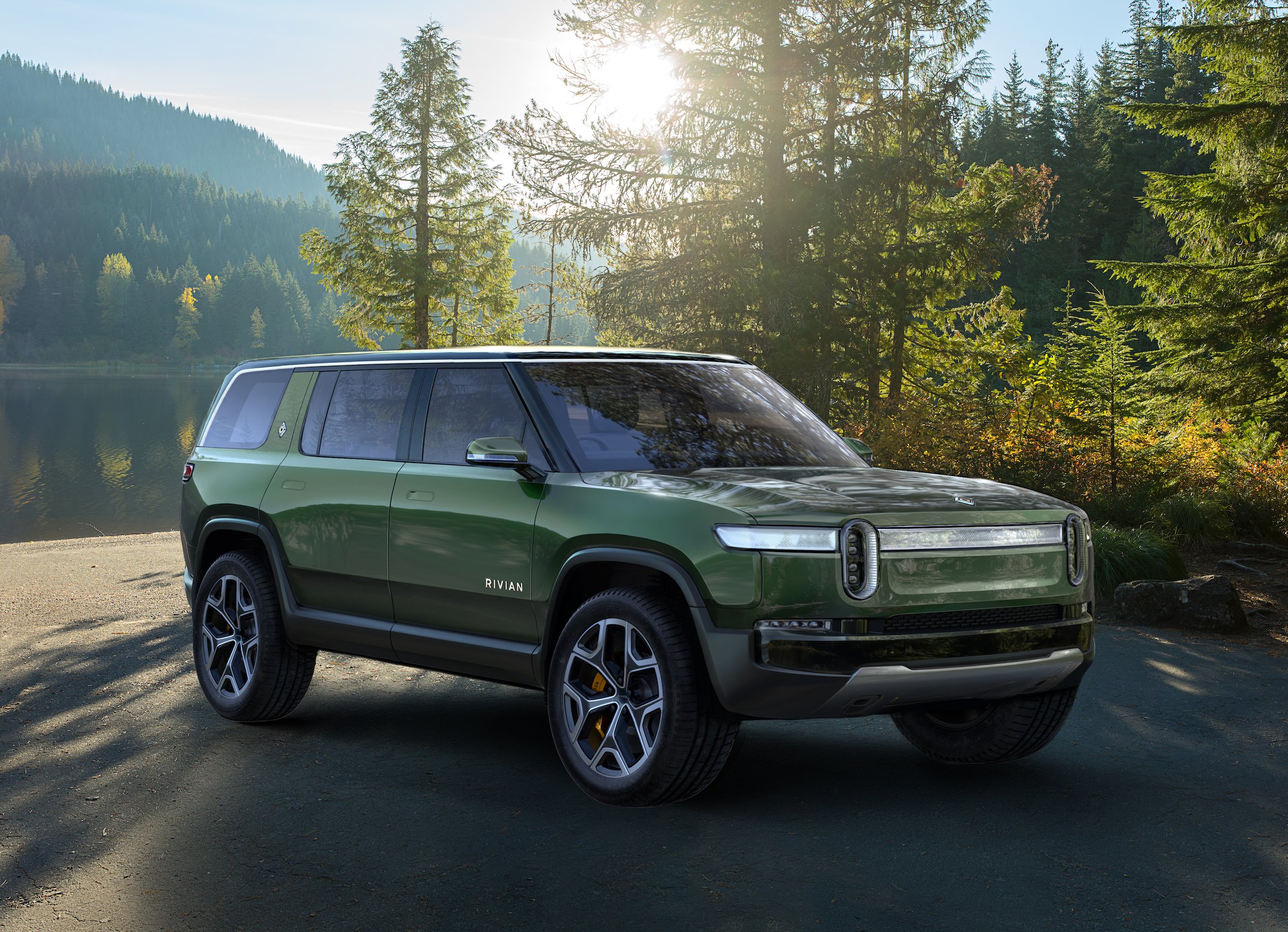 A green Rivian R1S, an upscale electric 7-passenger SUV.