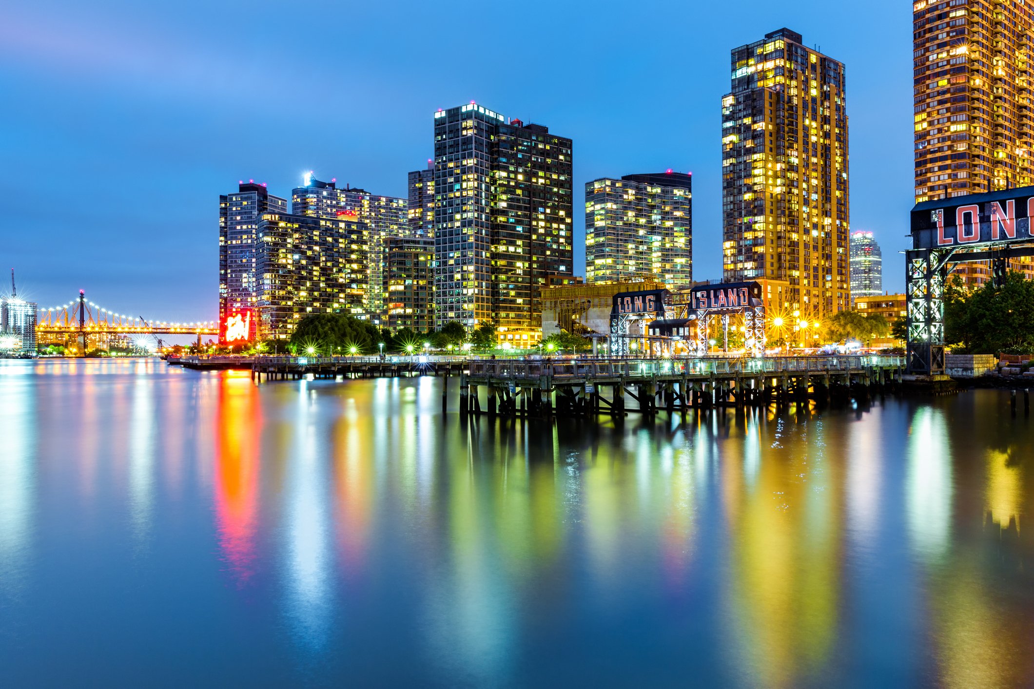 A "Long Island" sign against the Queens skyline