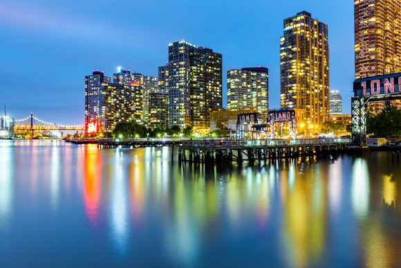 A "Long Island" sign against the Queens skyline