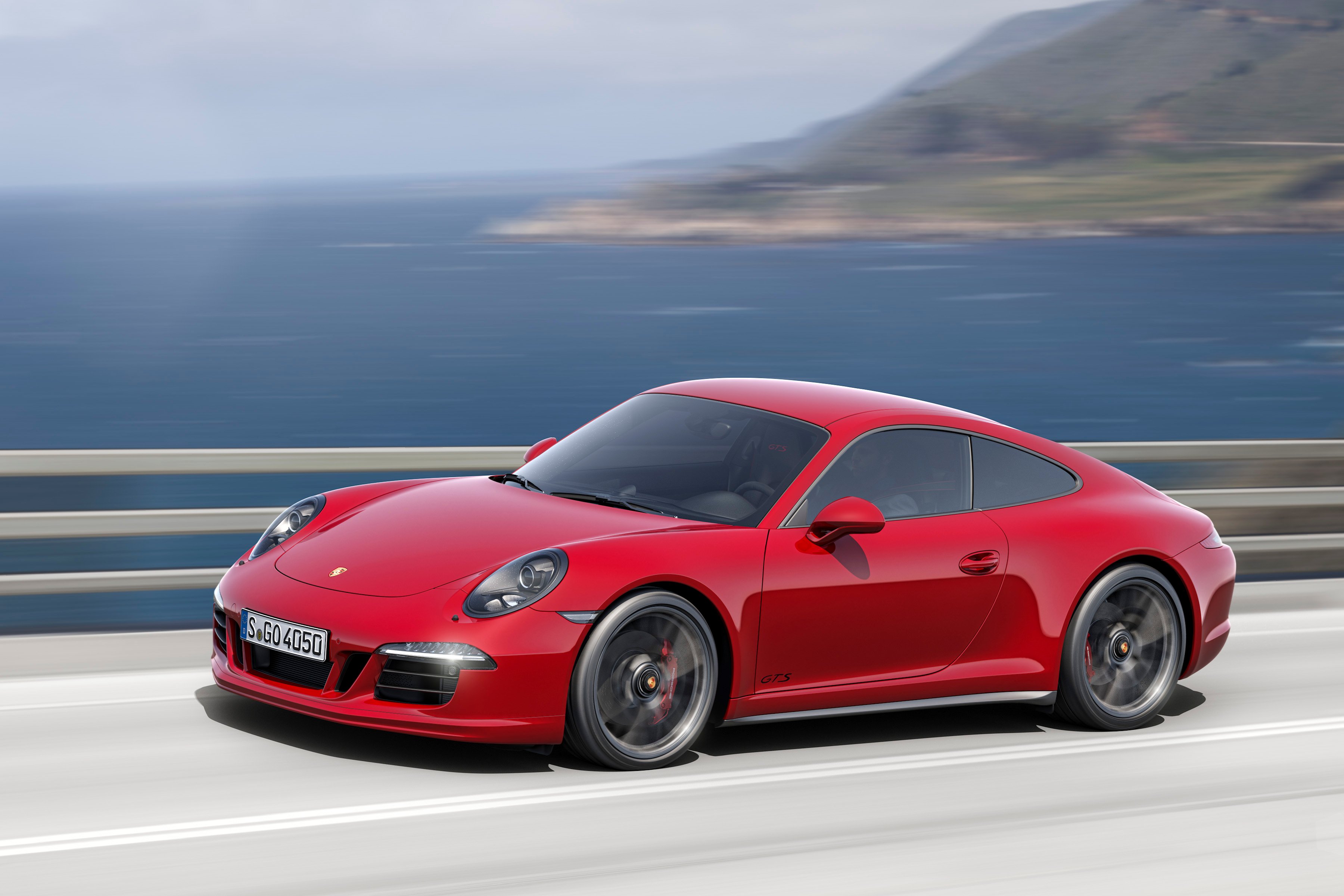 A red 2016 Porsche 911 sports car. 