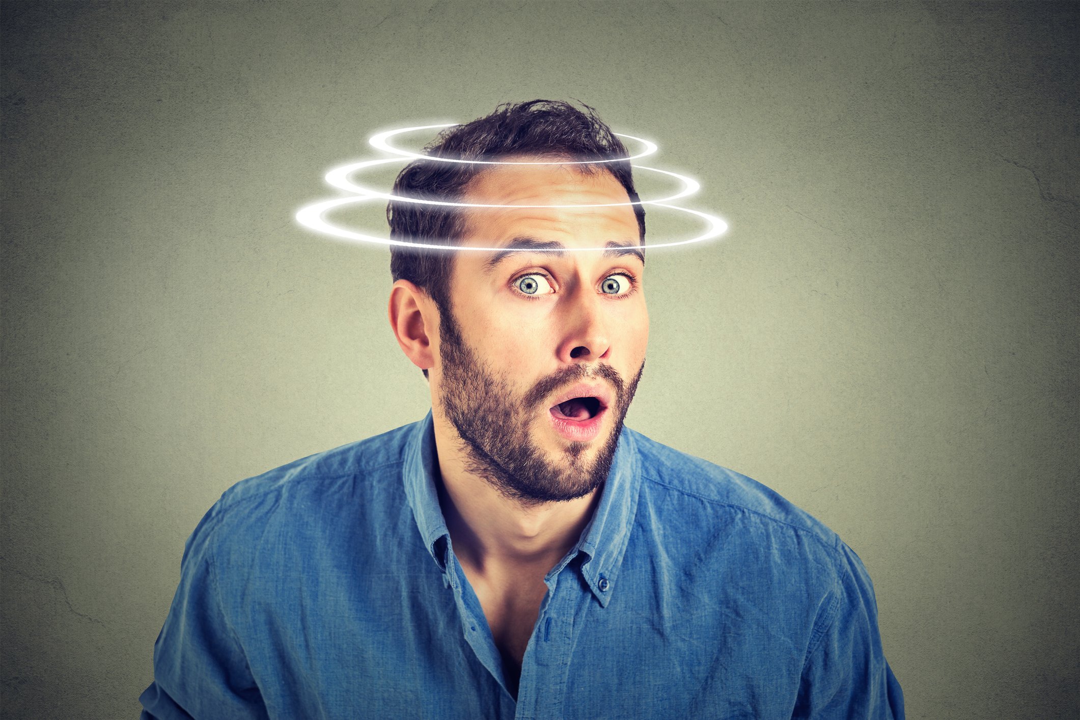 Surprised man with images of spirals over his head to give an impression that his head was spinning
