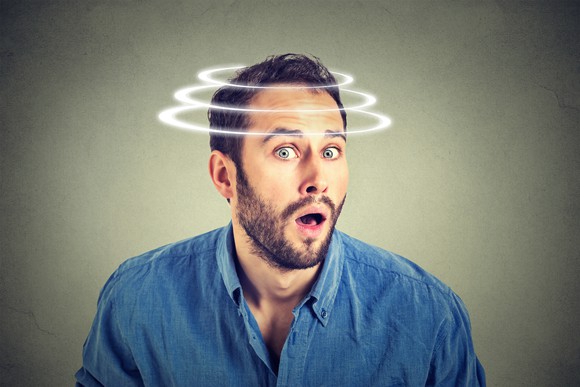 Surprised man with images of spirals over his head to give an impression that his head was spinning