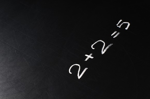 2+2=5 written on a chalkboard.