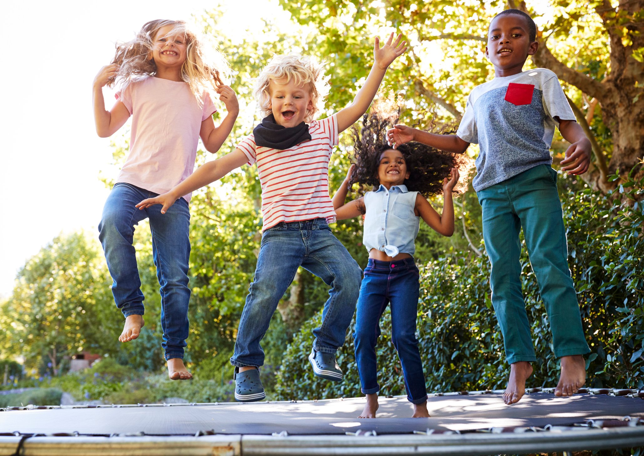 Four kids on a trampoline.