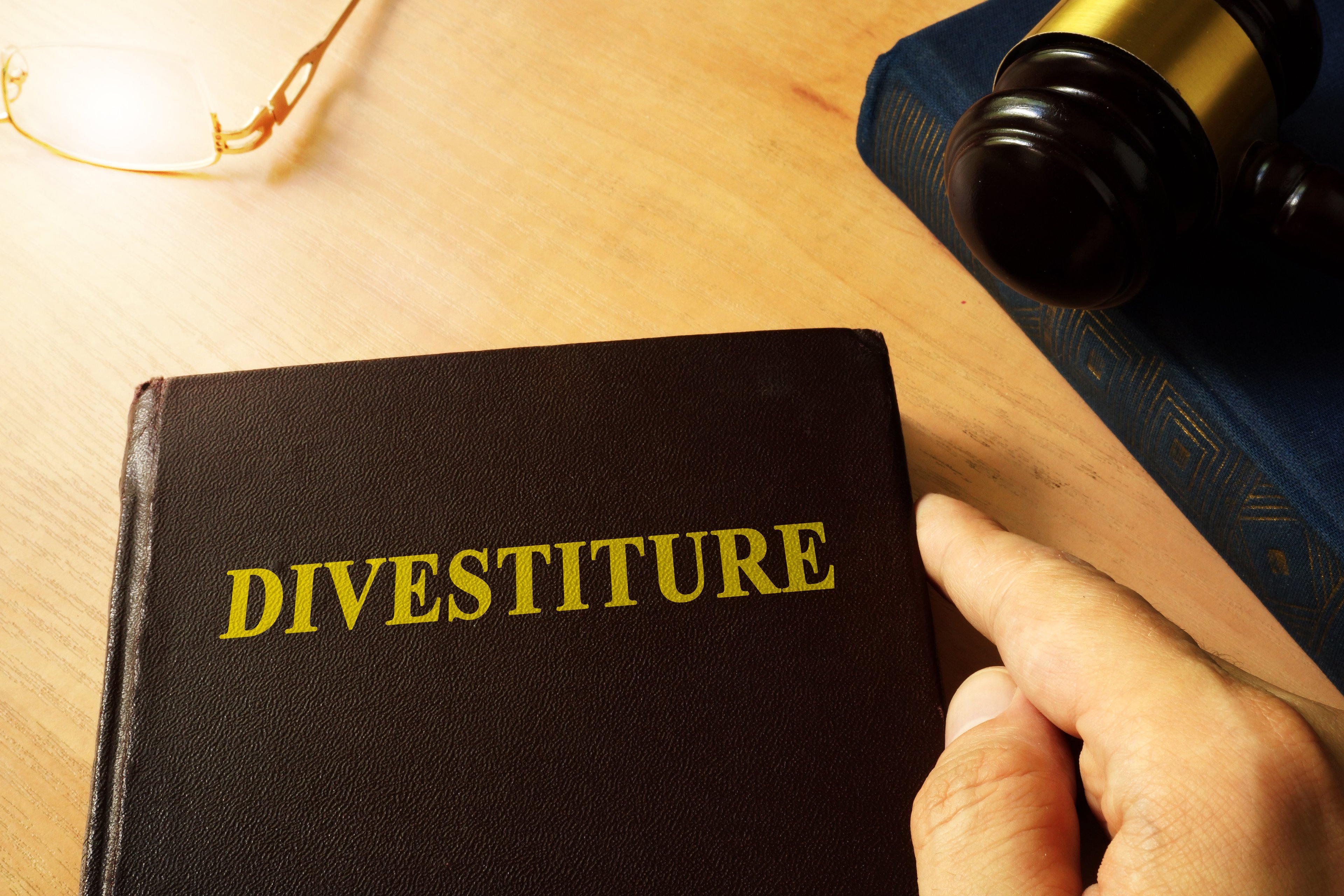 Book with divestiture written on the cover