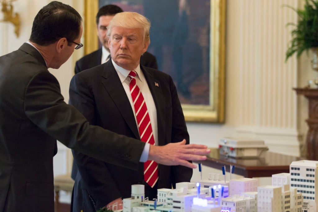 President Donald Trump with another man talking to him