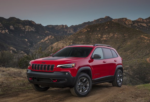 A red and black 2019 Jeep Cherokee parked up in the mountains. 