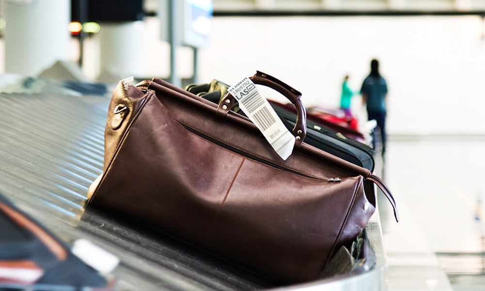 A bag with a tag on a luggage conveyor belt