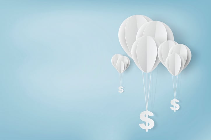 Paper balloons carrying dollar signs.