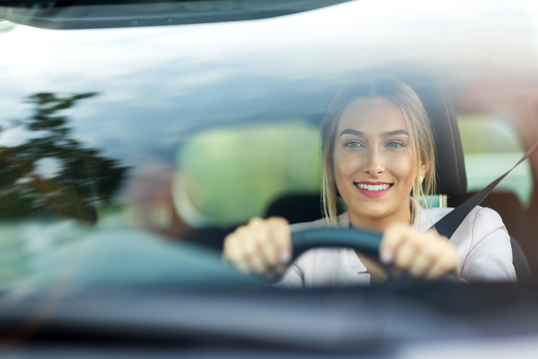 Woman driving a car, smiling