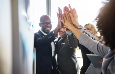 TEam of business people giving high fives