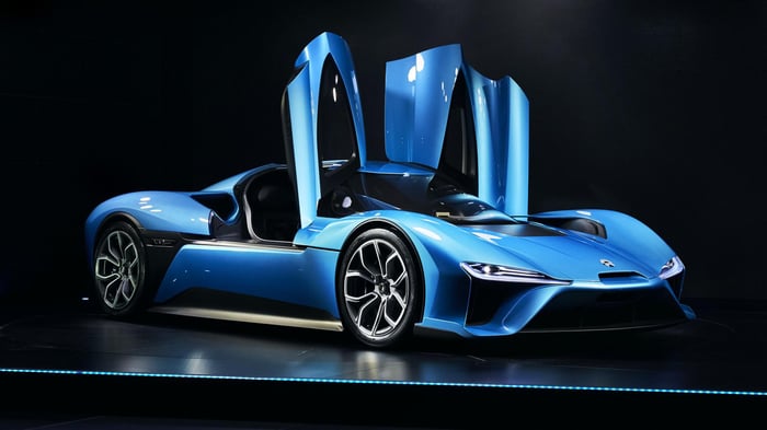 High-end luxury blue NIO automobile with doors opening vertically.