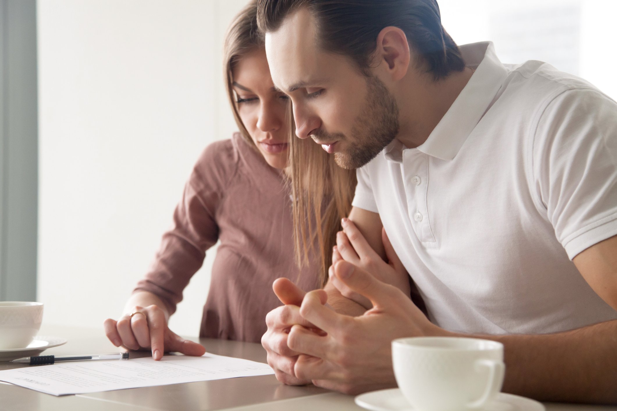 Young couple looking at a document.