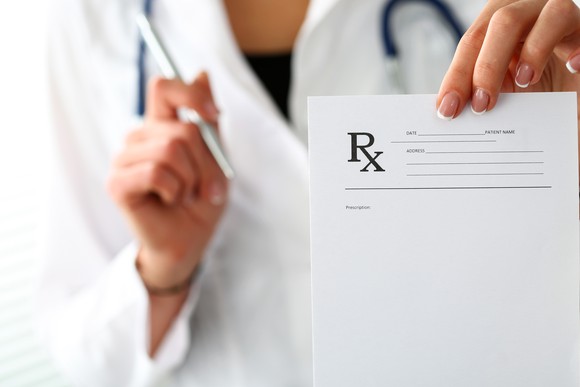 A doctor holding a prescription pad.