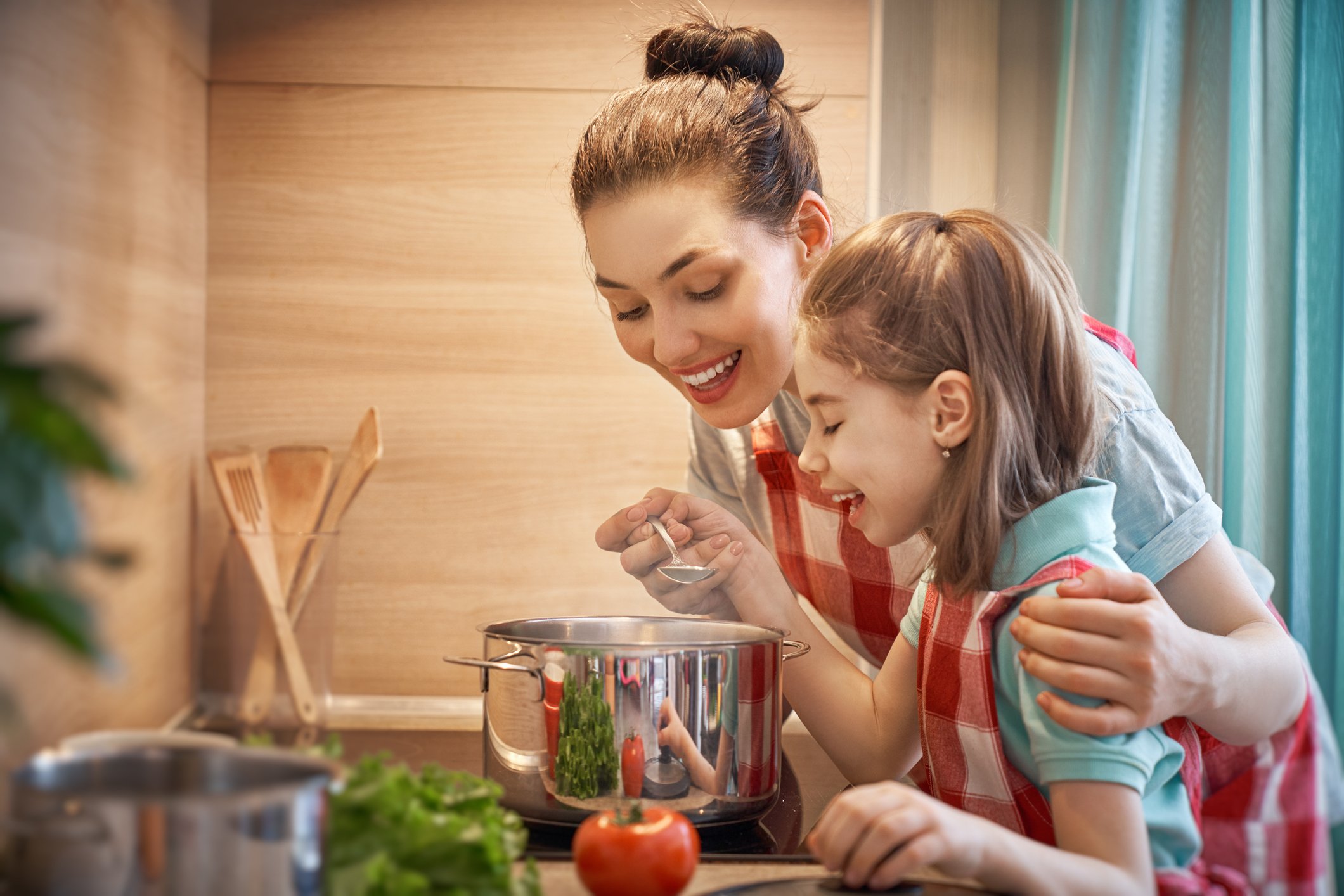 Woman and child heating up soup together