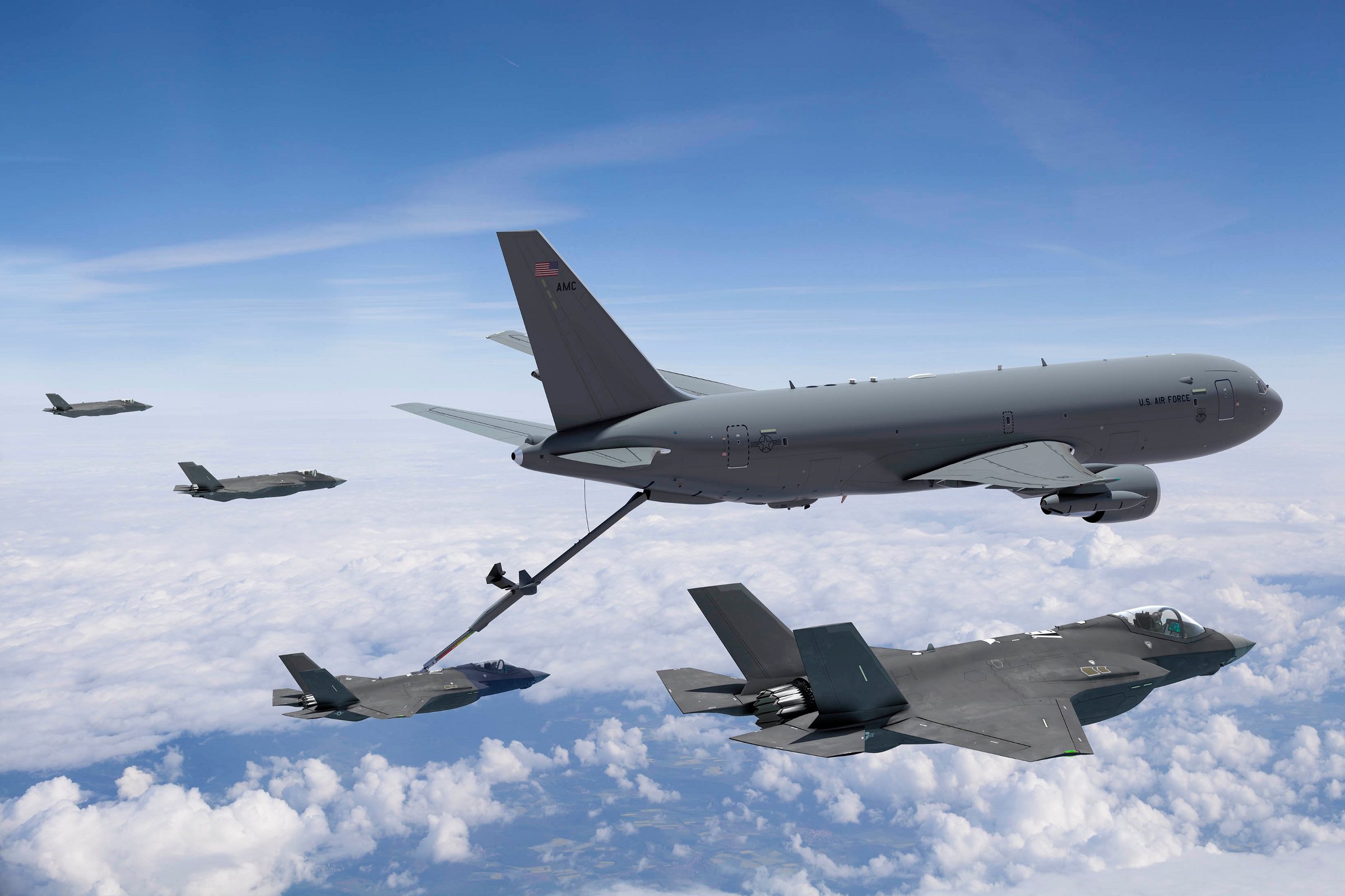 Two Boeing's KC-46 flying above the clouds in the sky. 
