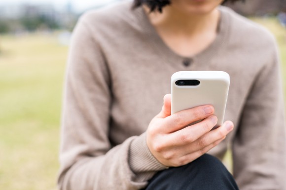 A woman using a mobile phone.