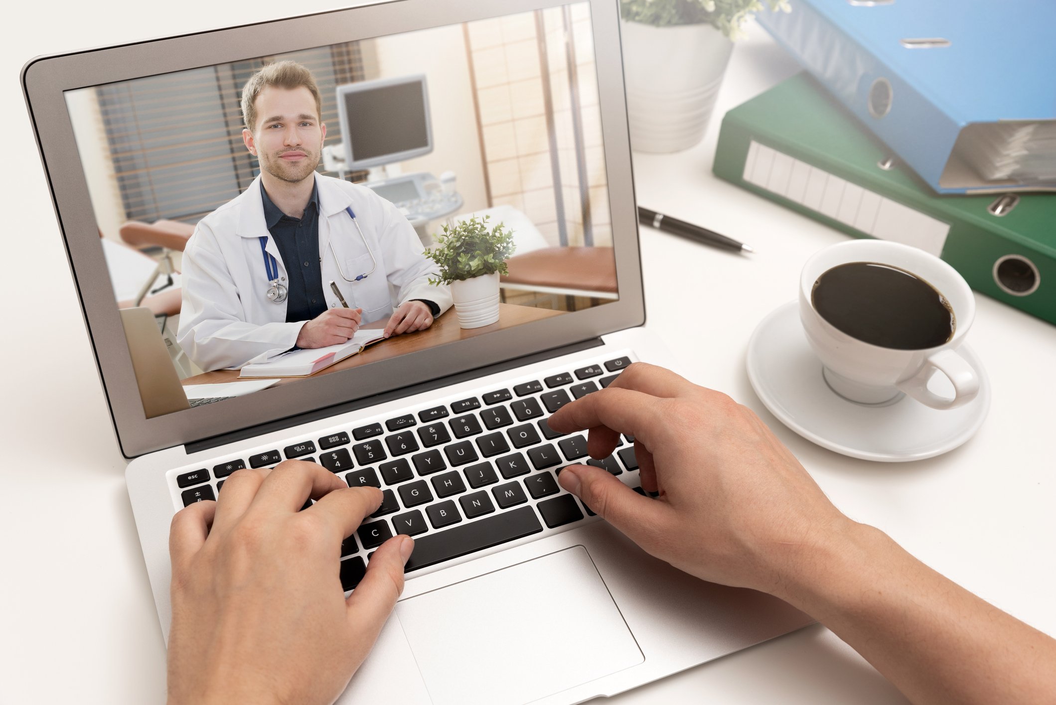 A customer visiting a doctor virtually with a laptop
