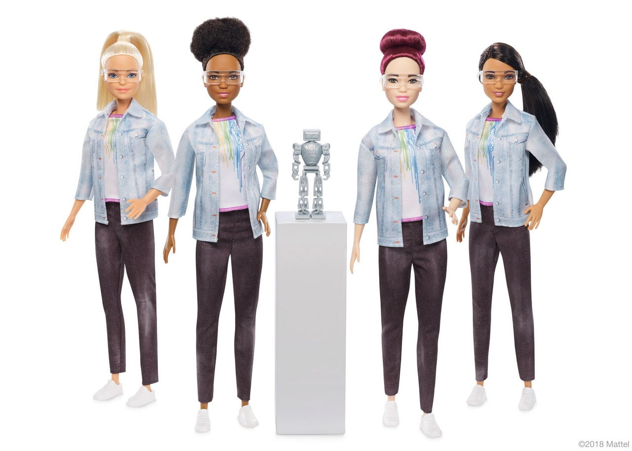 A number of Barbie dolls are dressed as robotics engineers.