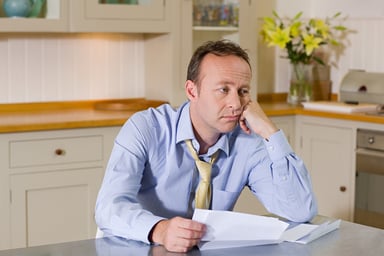 middle aged man with bills_GettyImages-92148819
