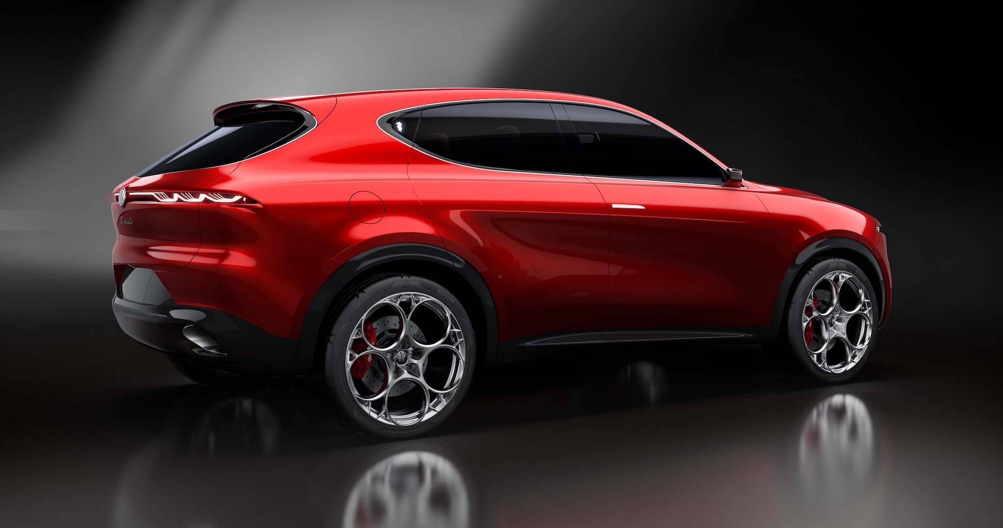 A rear three-quarter view of the Alfa Romeo Tonale Concept, a sporty red crossover SUV