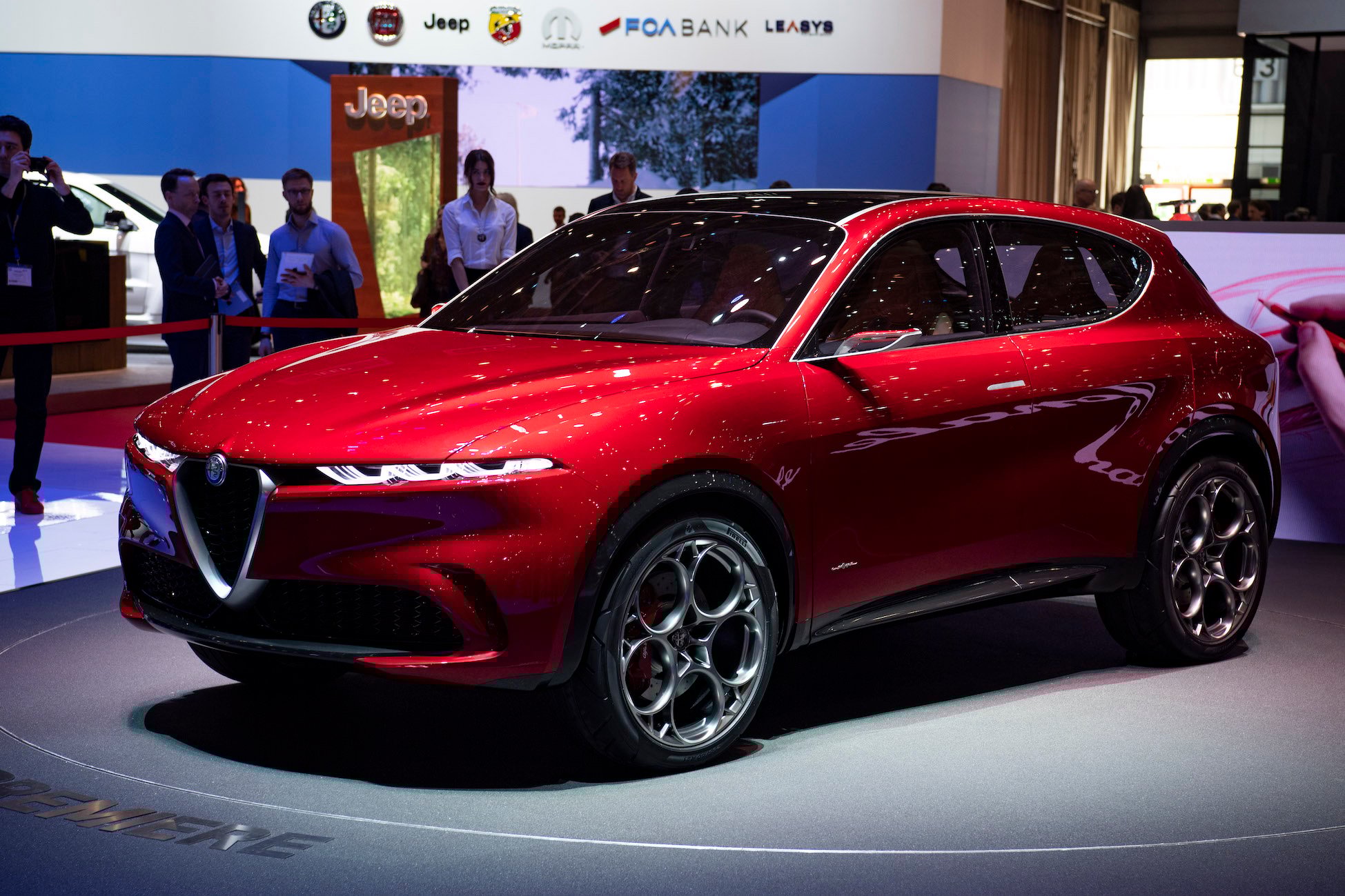 The Alfa Romeo Tonale Concept, a sporty bright red compact crossover SUV, shown at the Geneva Motor Show