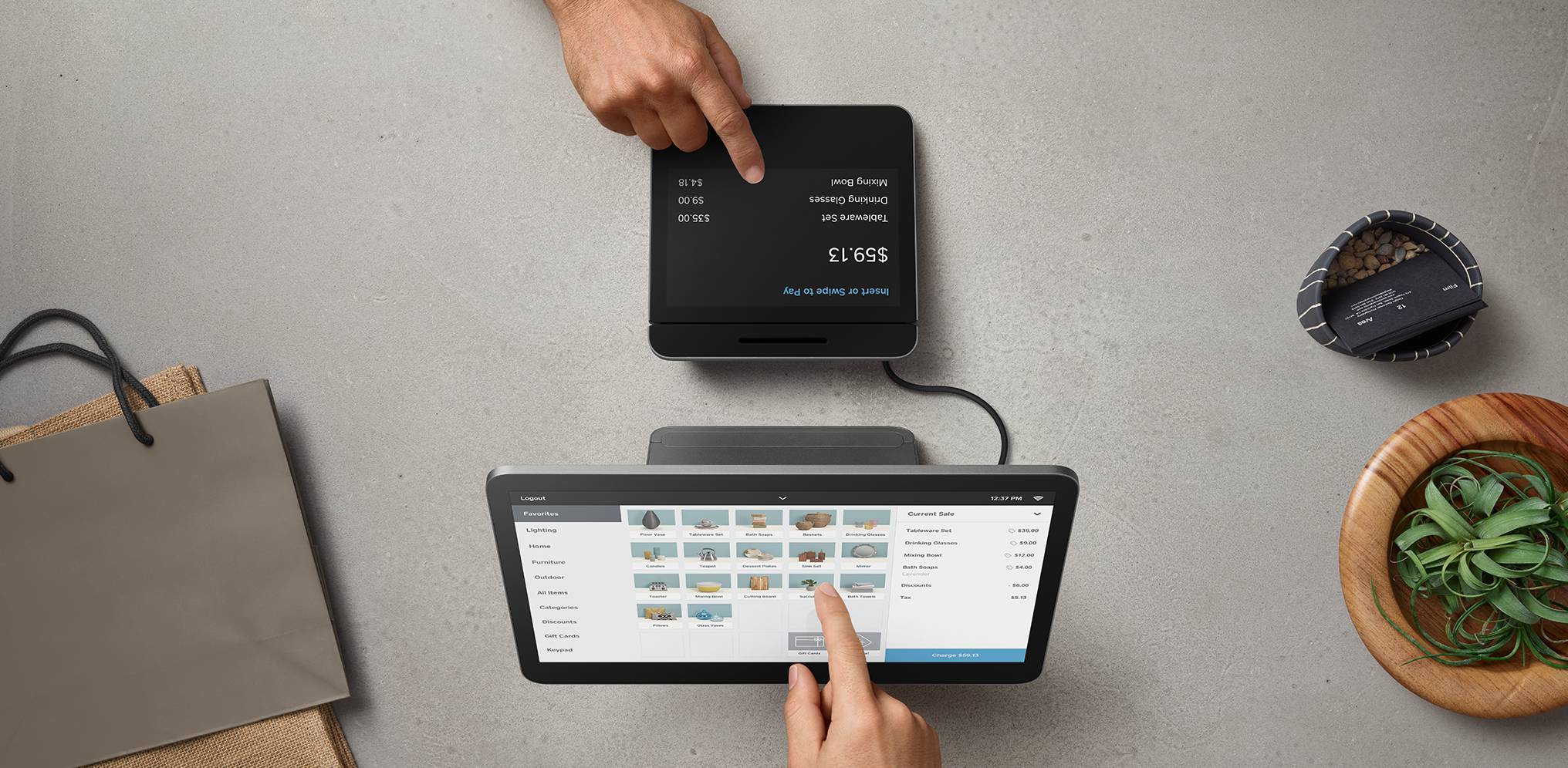 A merchant's hand and a customer's hand interacting with a Square register at checkout.