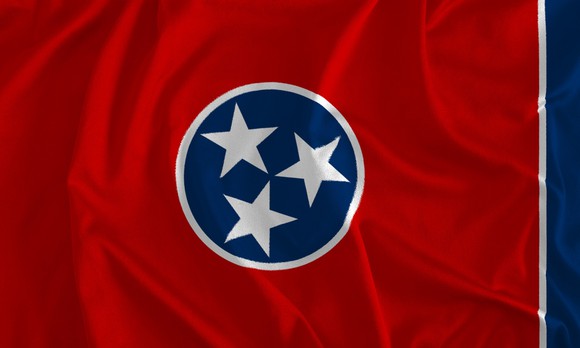 Flag with red background and centered circle with blue background and three white stars.