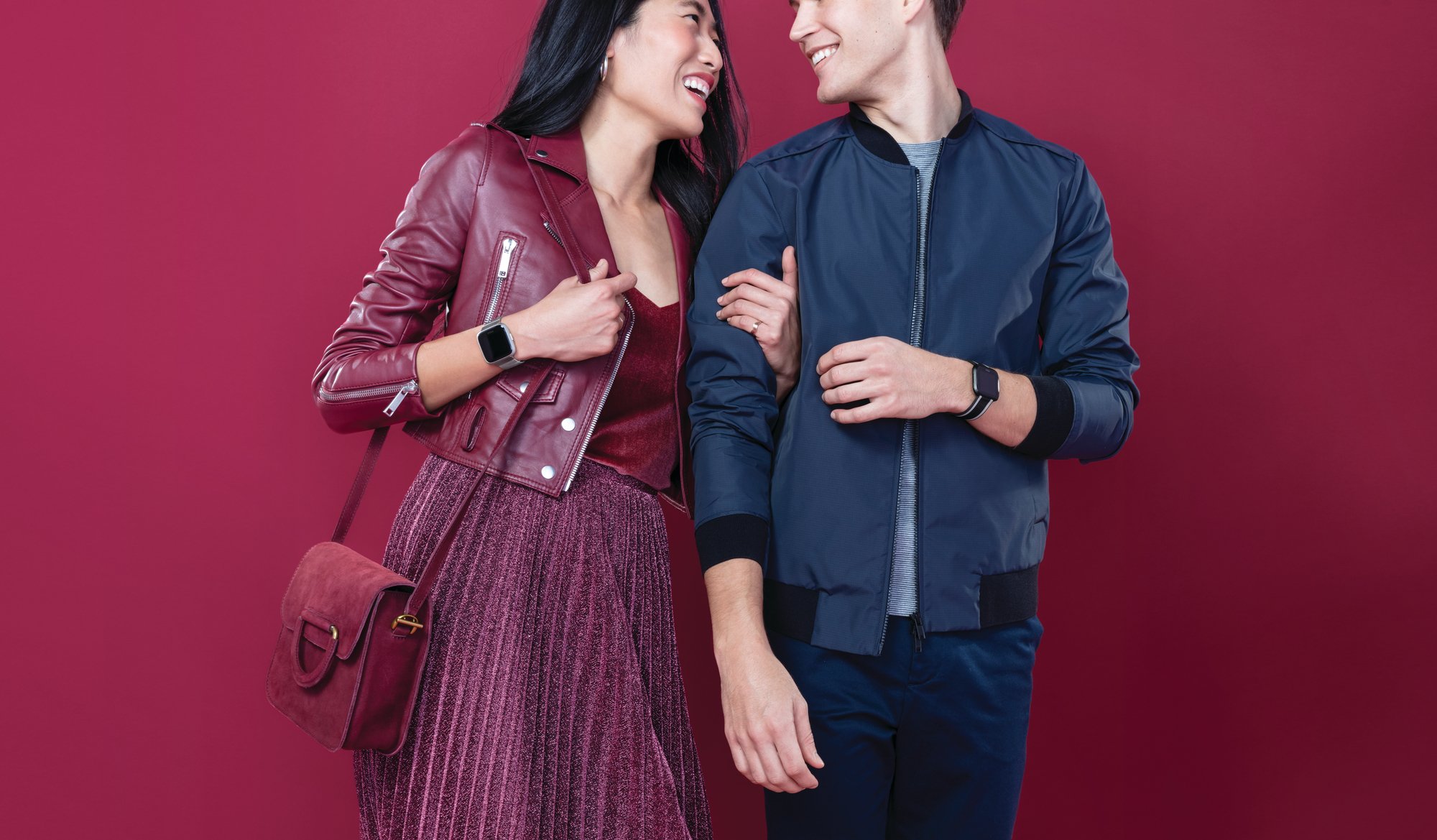 A couple wearing Fitbit Versa Lite Edition devices