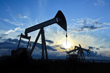 Group of pump-jacks drilling in silhouette