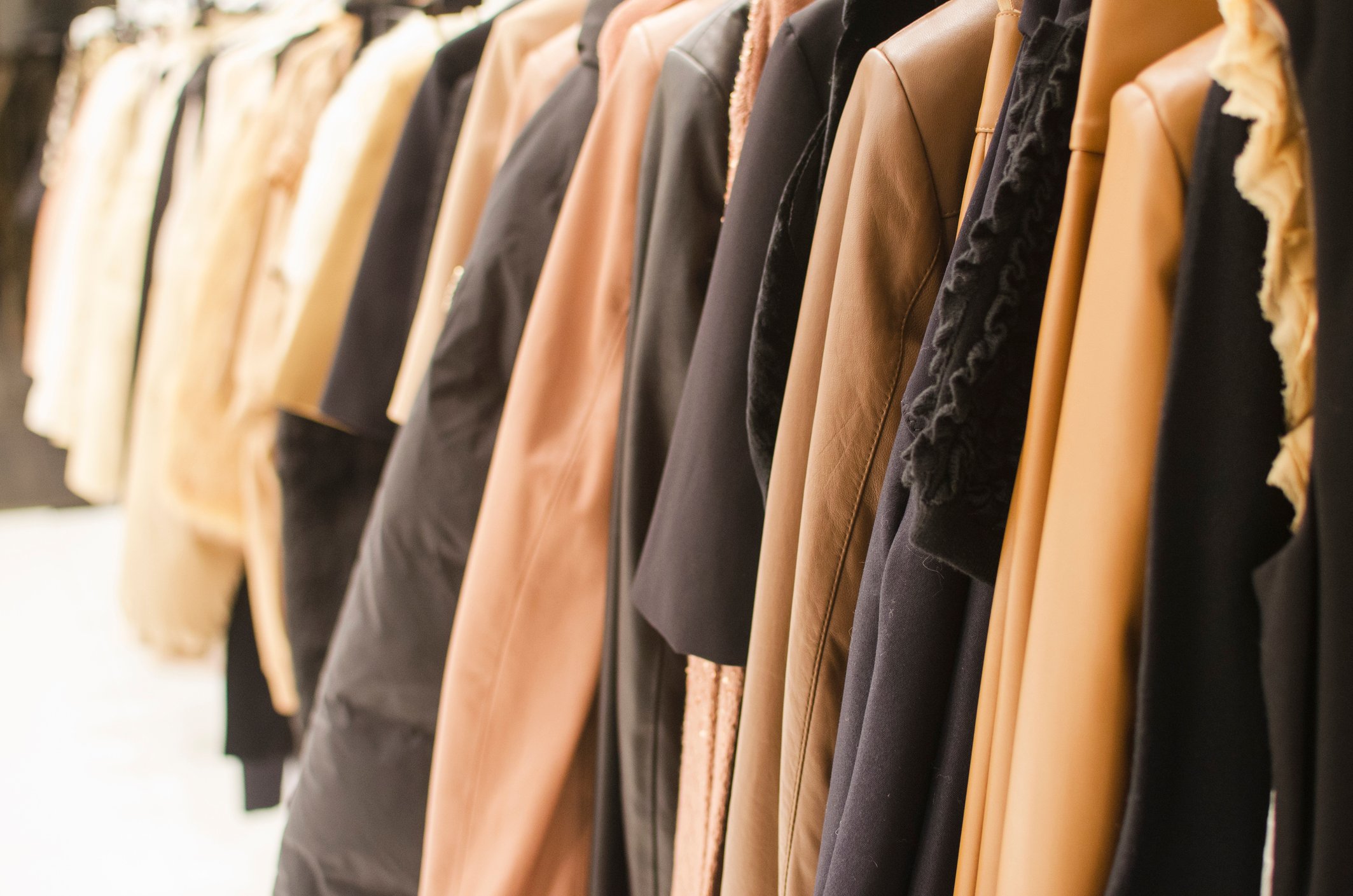 A rack of coats at a retail store.