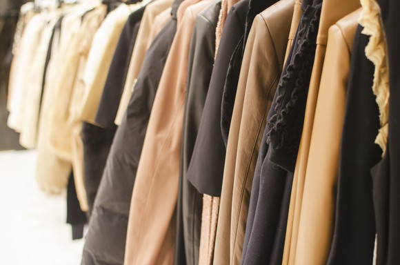 A rack of coats at a retail store.