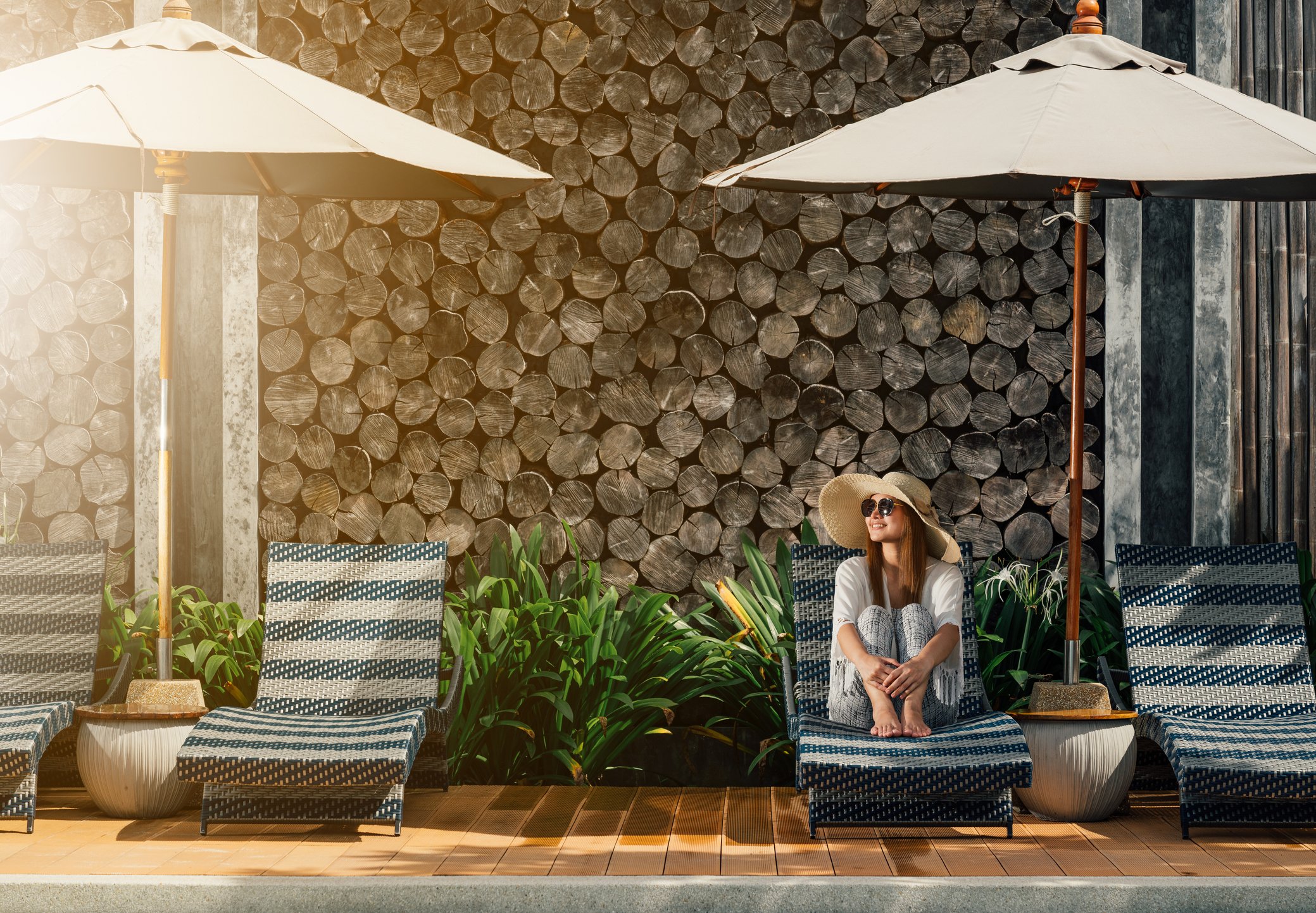 A woman lounging by a hotel pool
