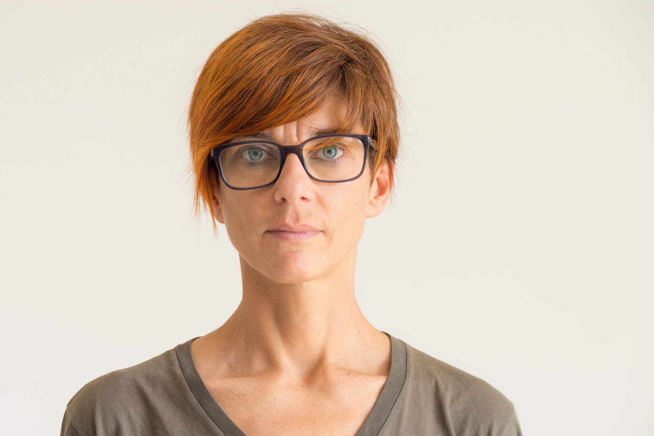 Closeup of woman with short red hair and glasses