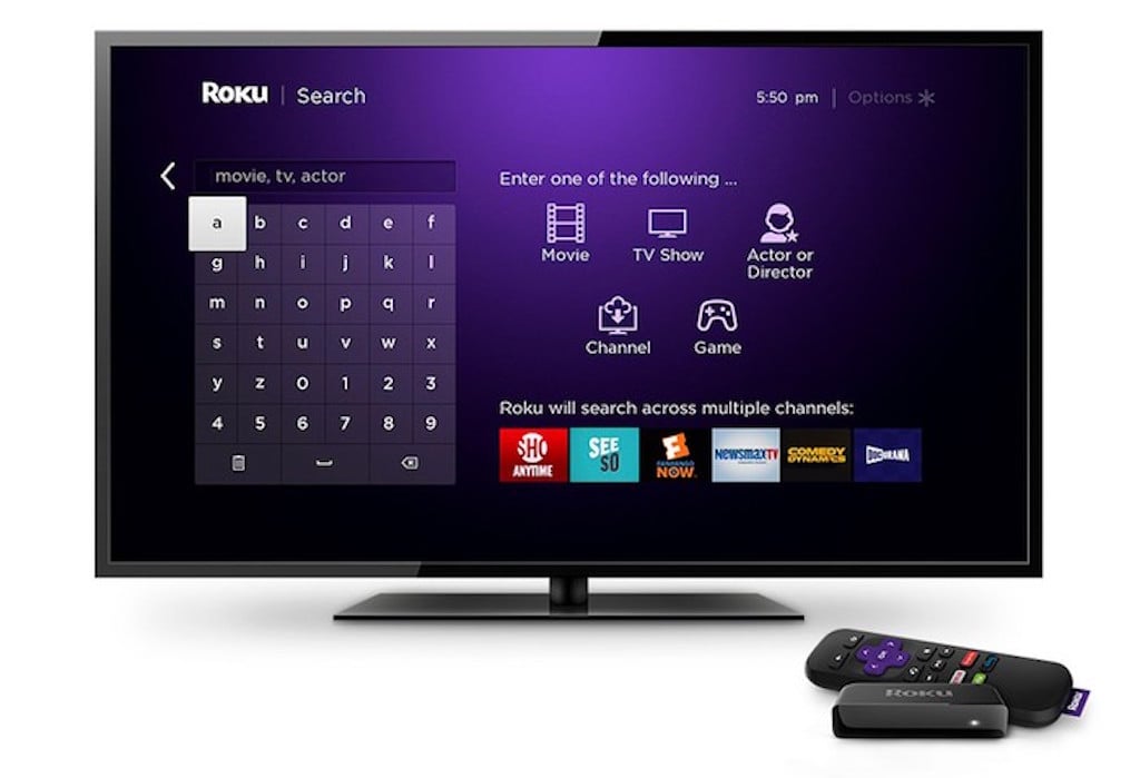 Roku TV with streaming devices in front of it.