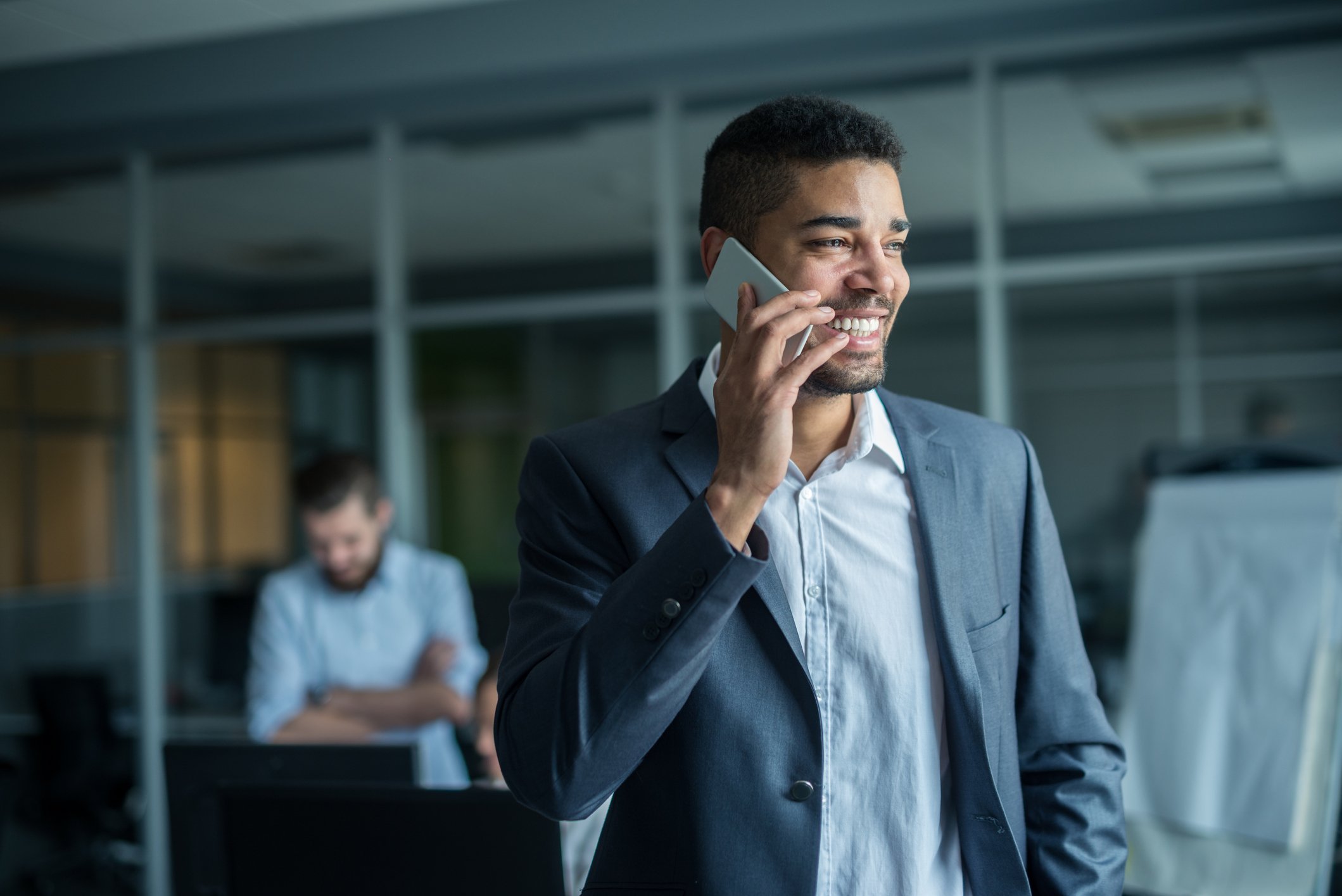 Professionally dressed man talking on cell phone