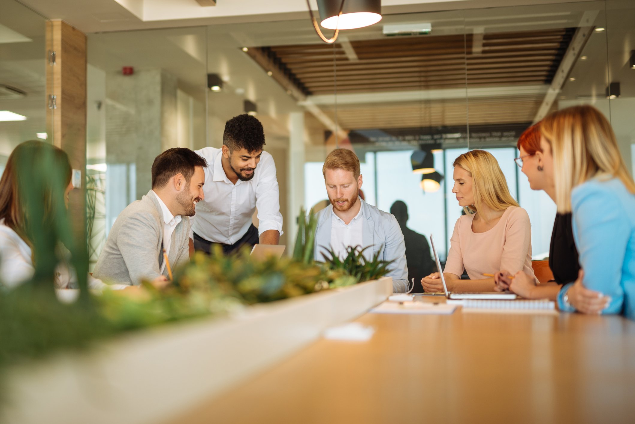 Group of professionally dressed adults gathering around a table