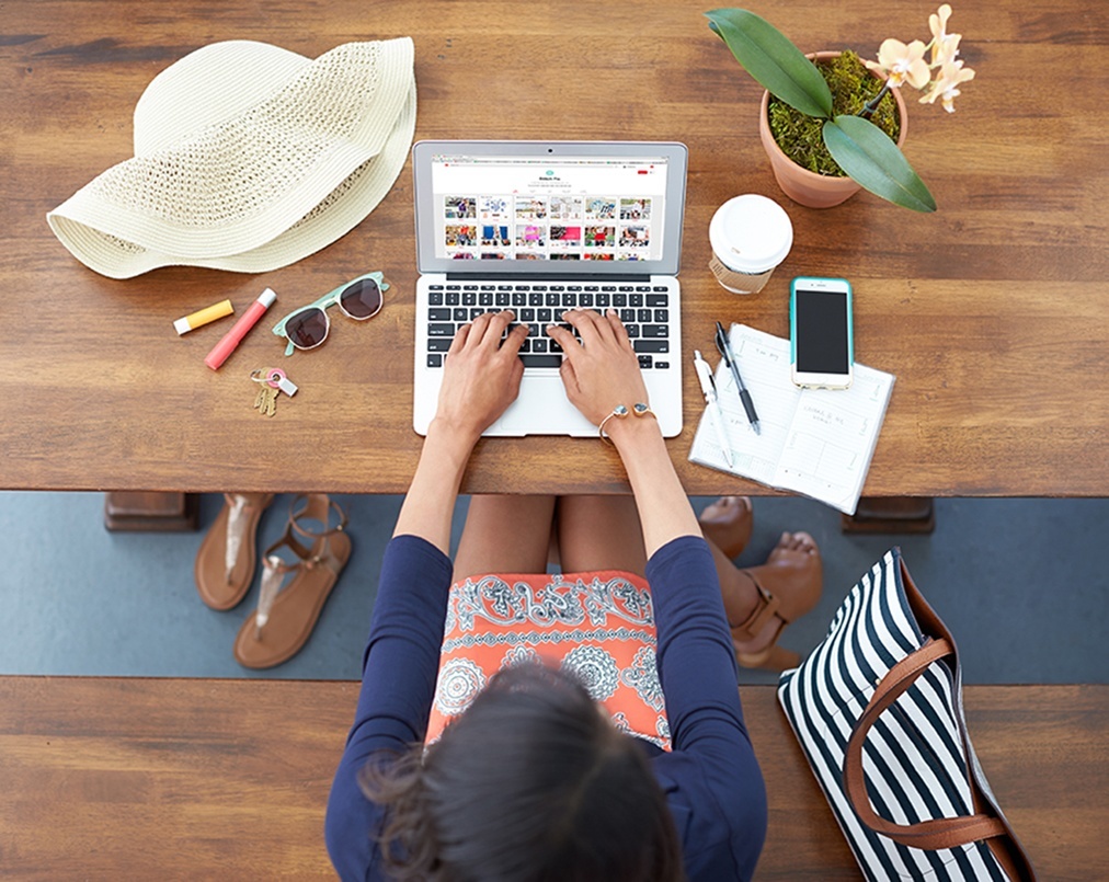Woman browsing Stitch Fix website on laptop.